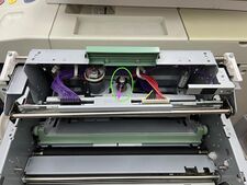 Removing the black plastic snap ring and spring. (The cables are shown connected in this image but should be removed first.)