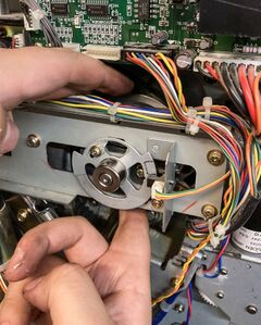 Slowly turning the cam pulley with fingertips above and below (grabbing pulley directly, beneath the belt).